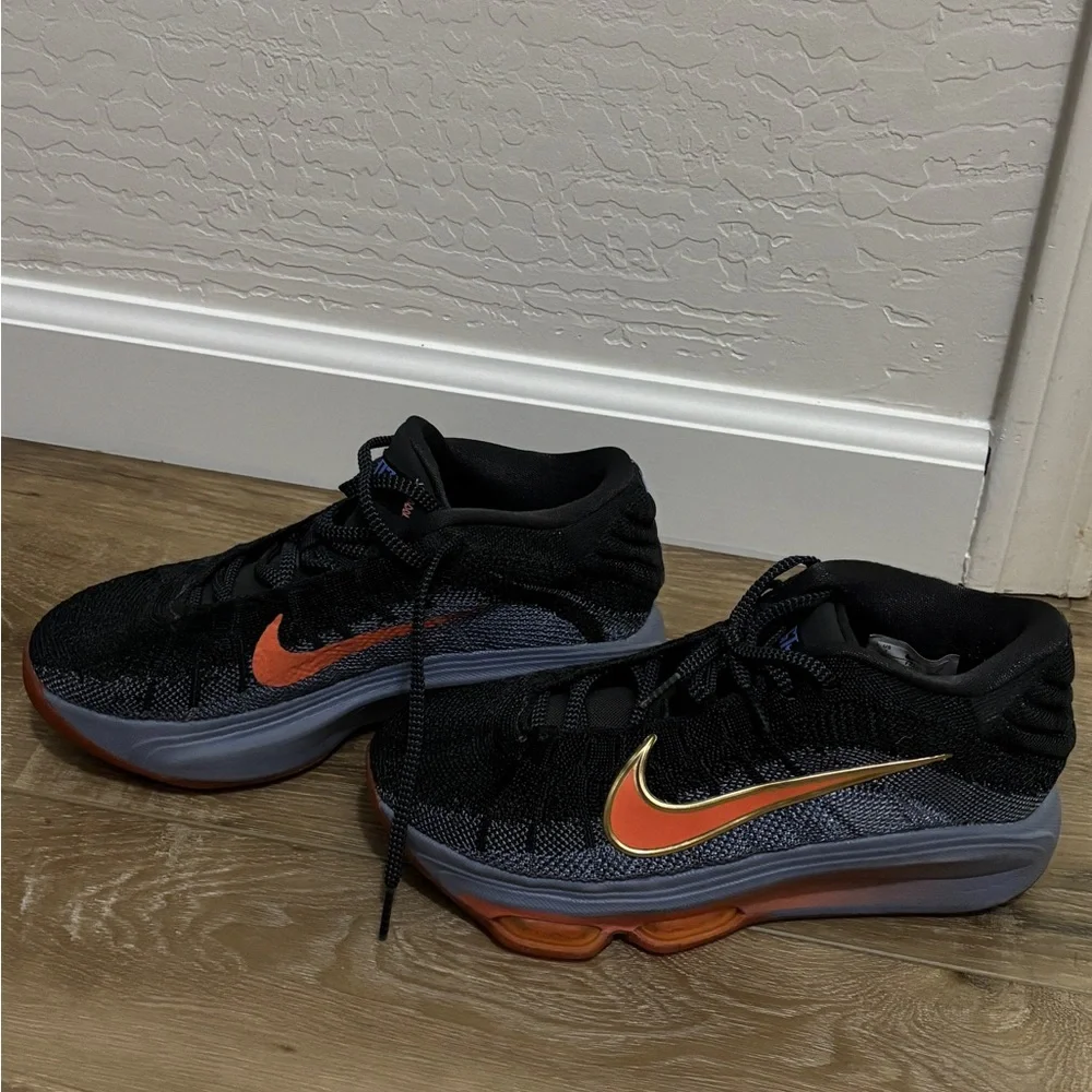 Nike Black Low-Top Sneakers with Orange & Gold Swoosh. Court shoes.